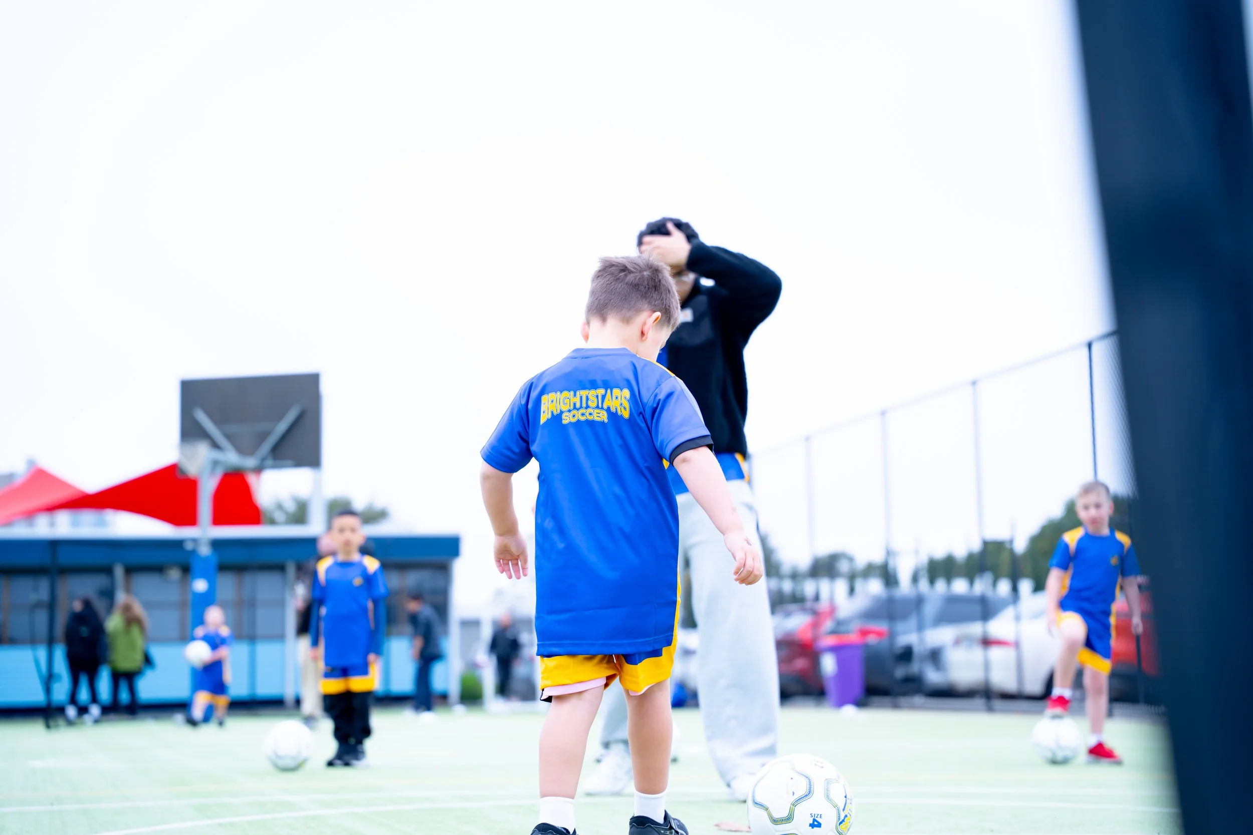 Children playing soccer on a field during daytime