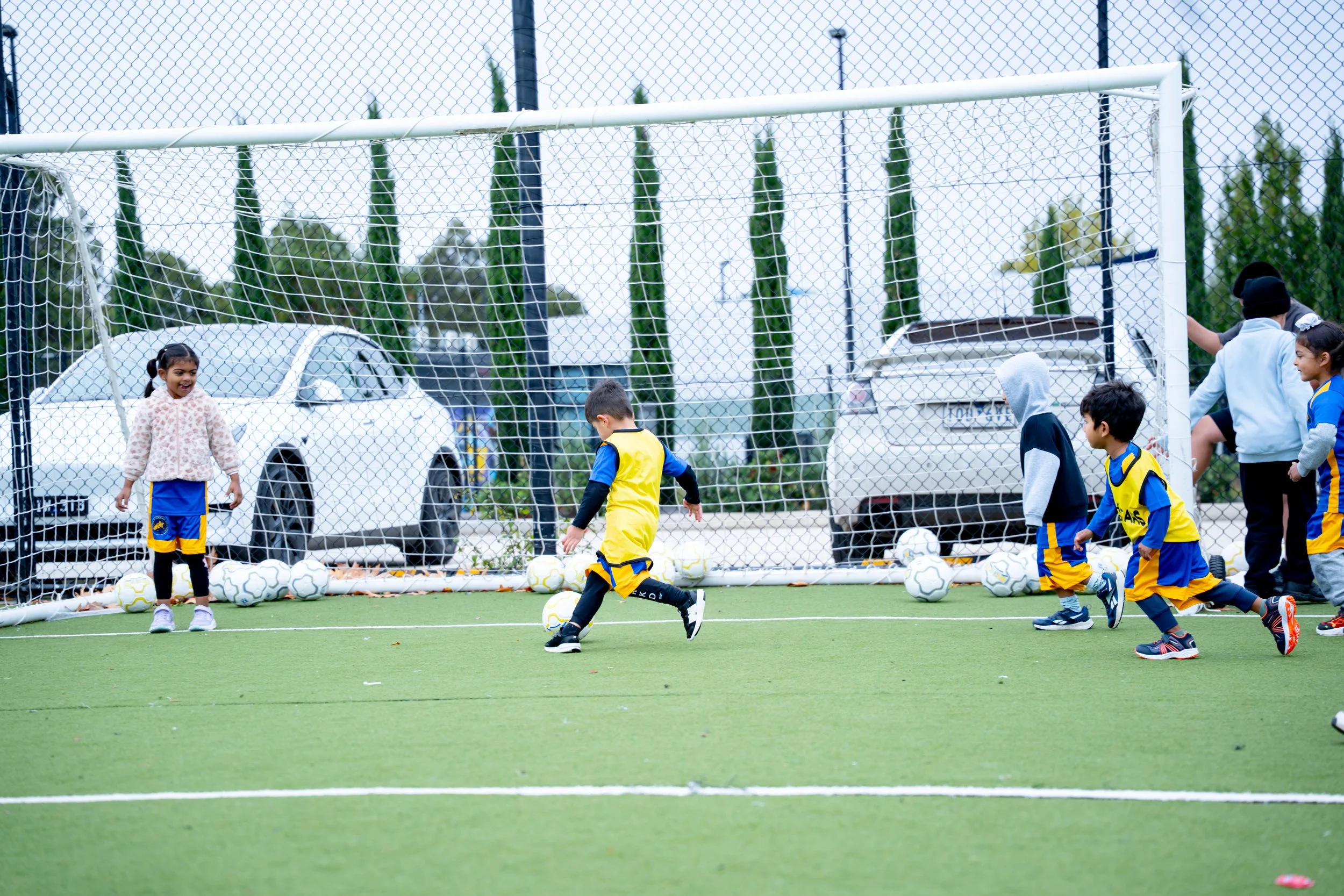 Children playing soccer on an outdoor field