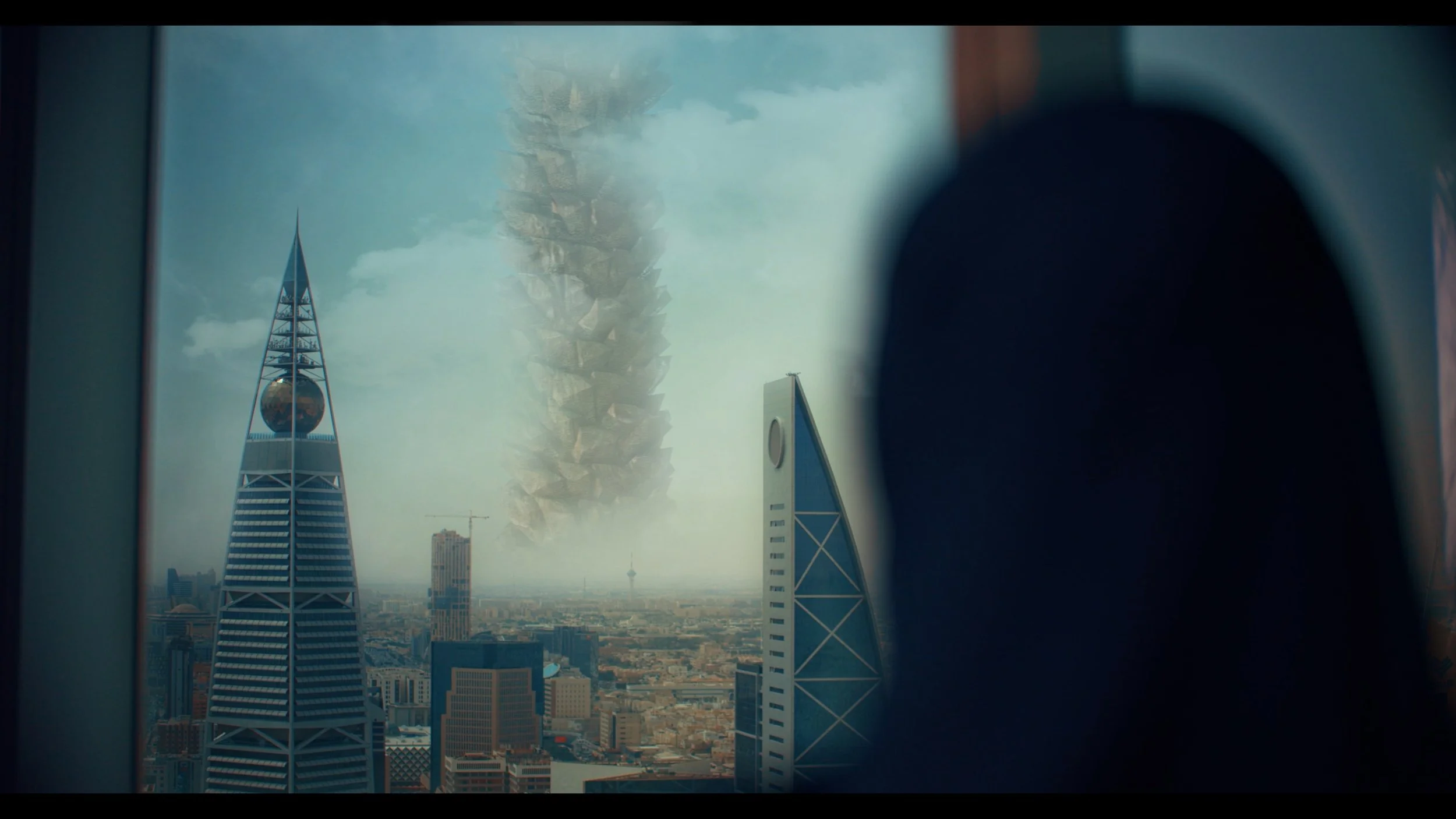 View of city skyline with futuristic skyscrapers, a volcanic eruption in the distance, and a large swirling tornado in the sky.