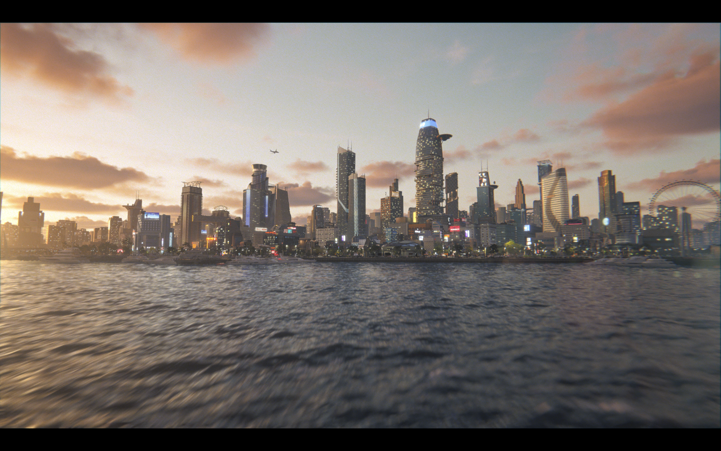 Sunset over San Francisco skyline with tall buildings, water in foreground, and a partly cloudy sky.