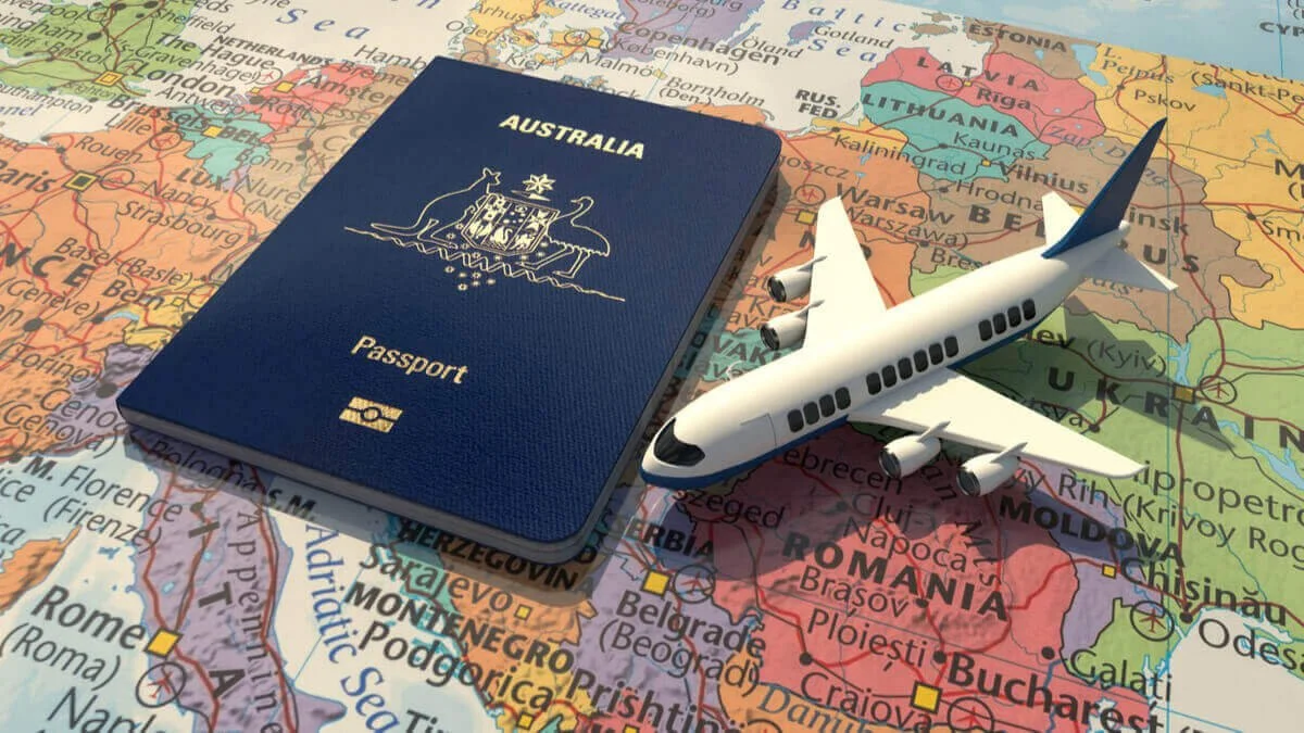 A travel-themed image featuring a blue Australian passport, a toy airplane, and a world map with European countries visible.