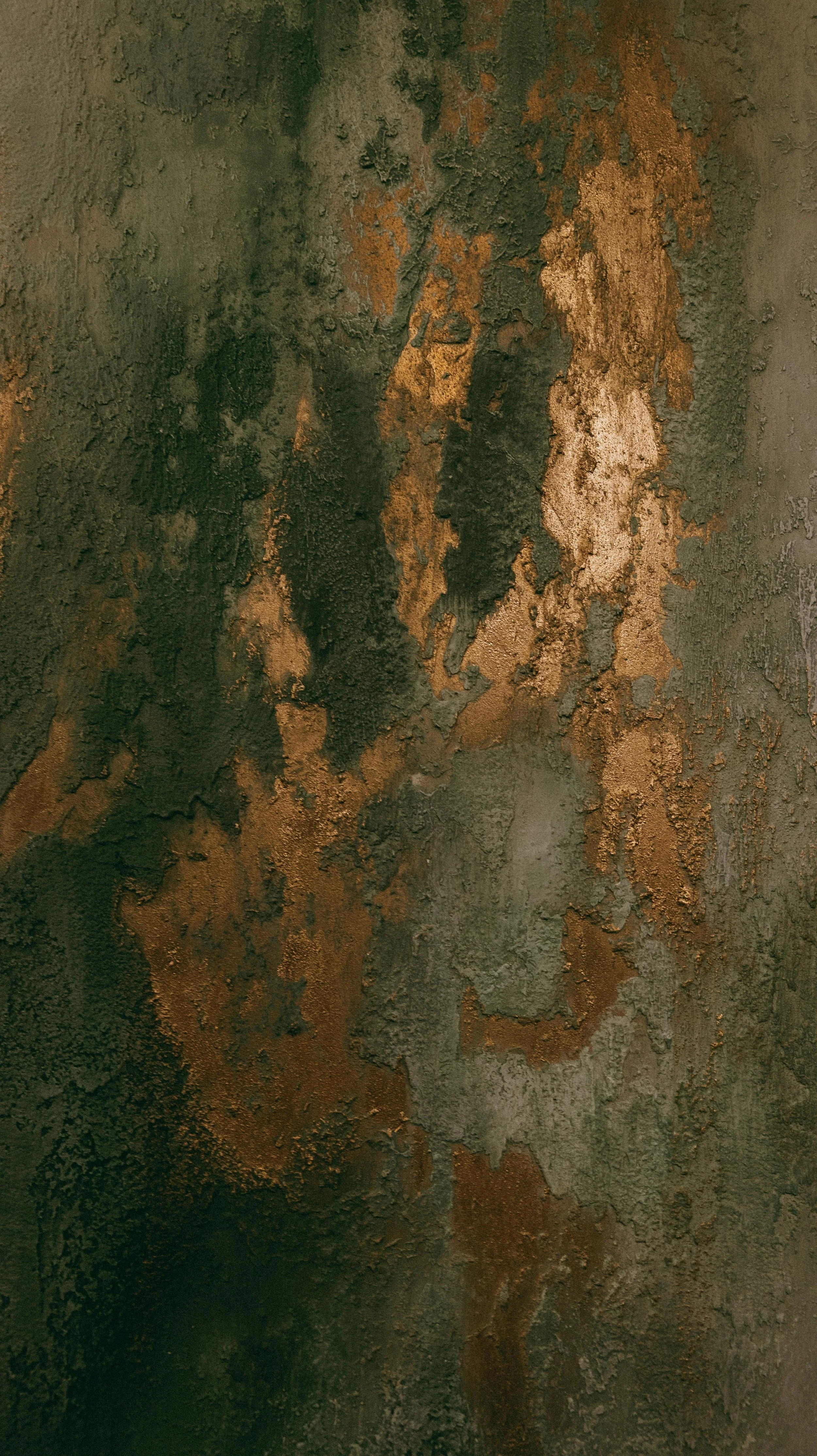 Close-up of a textured, rusted metal surface with patches of peeling paint and corrosion.