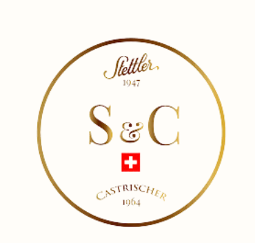 A circular logo with a gold outline and text, featuring 'Stettler 1947' at the top, 'Castrischer 1964' at the bottom, and 'S & C' in the center with a red Swiss flag below.