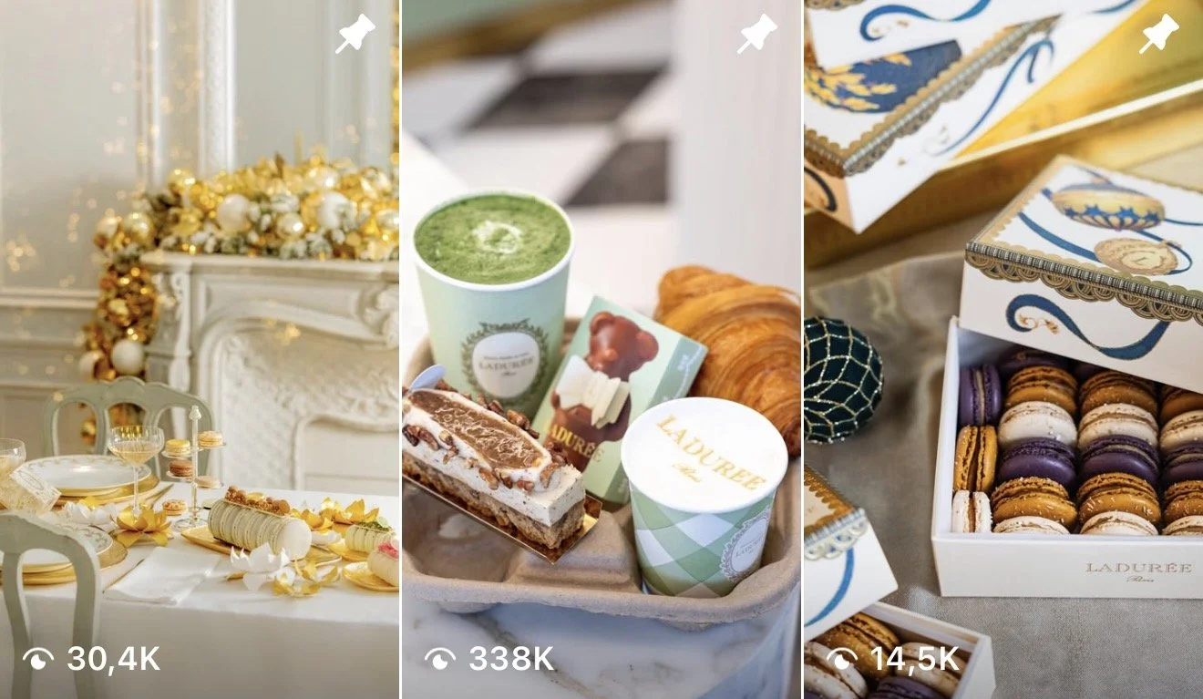 An elegant dining setting with a decorated table, a tray of green matcha tea, croissants, and assorted macarons in boxes.