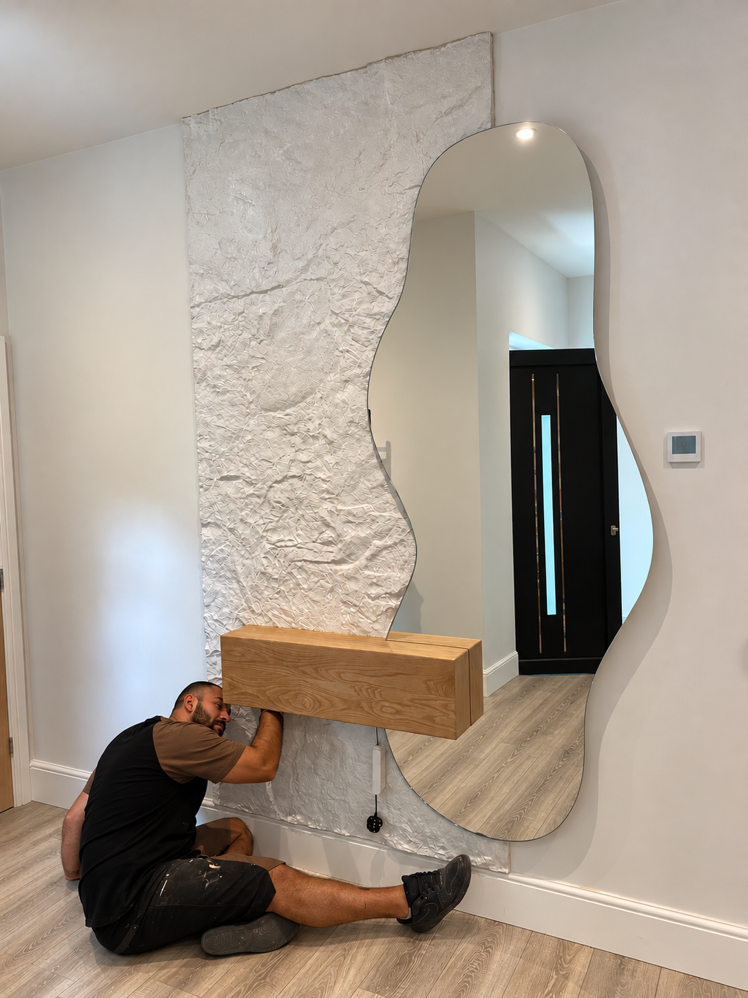 Installation of the Monolith bespoke mirror, floating oak shelf and textured wall feature by BCreative Bespoke