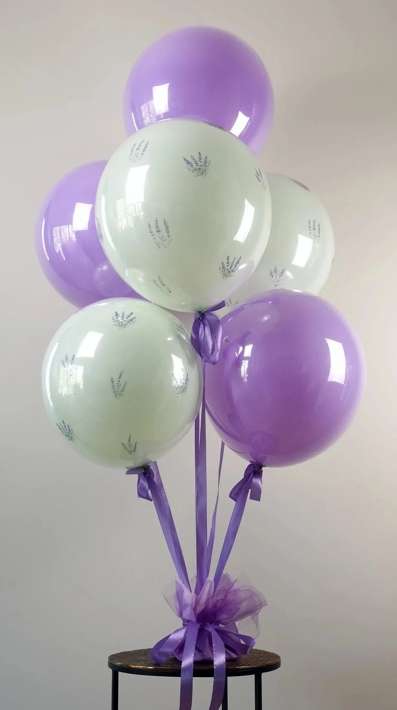 Inspired by the French countryside, La Provence is a soft and romantic bouquet with pastel green and purple balloons, adorned with lavender blossoms, and gathered together with satin ribbons.  This arrangement is perfect for garden parties, birthdays