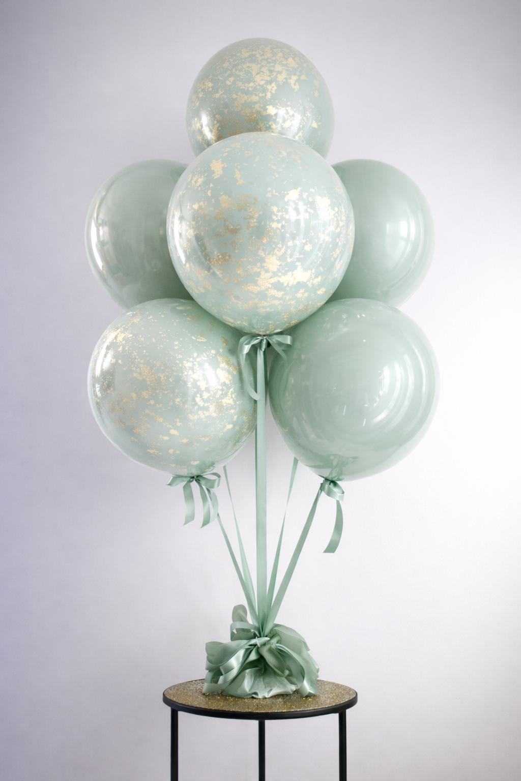 Sage green balloons with gold accents.png