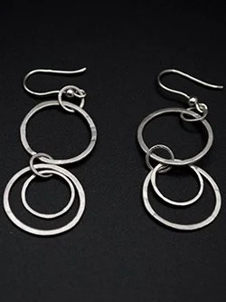 Handmade sterling silver double hoop dangle earrings with graduated hammered circles on French hook ear wires, handcrafted by Jennifer Morris