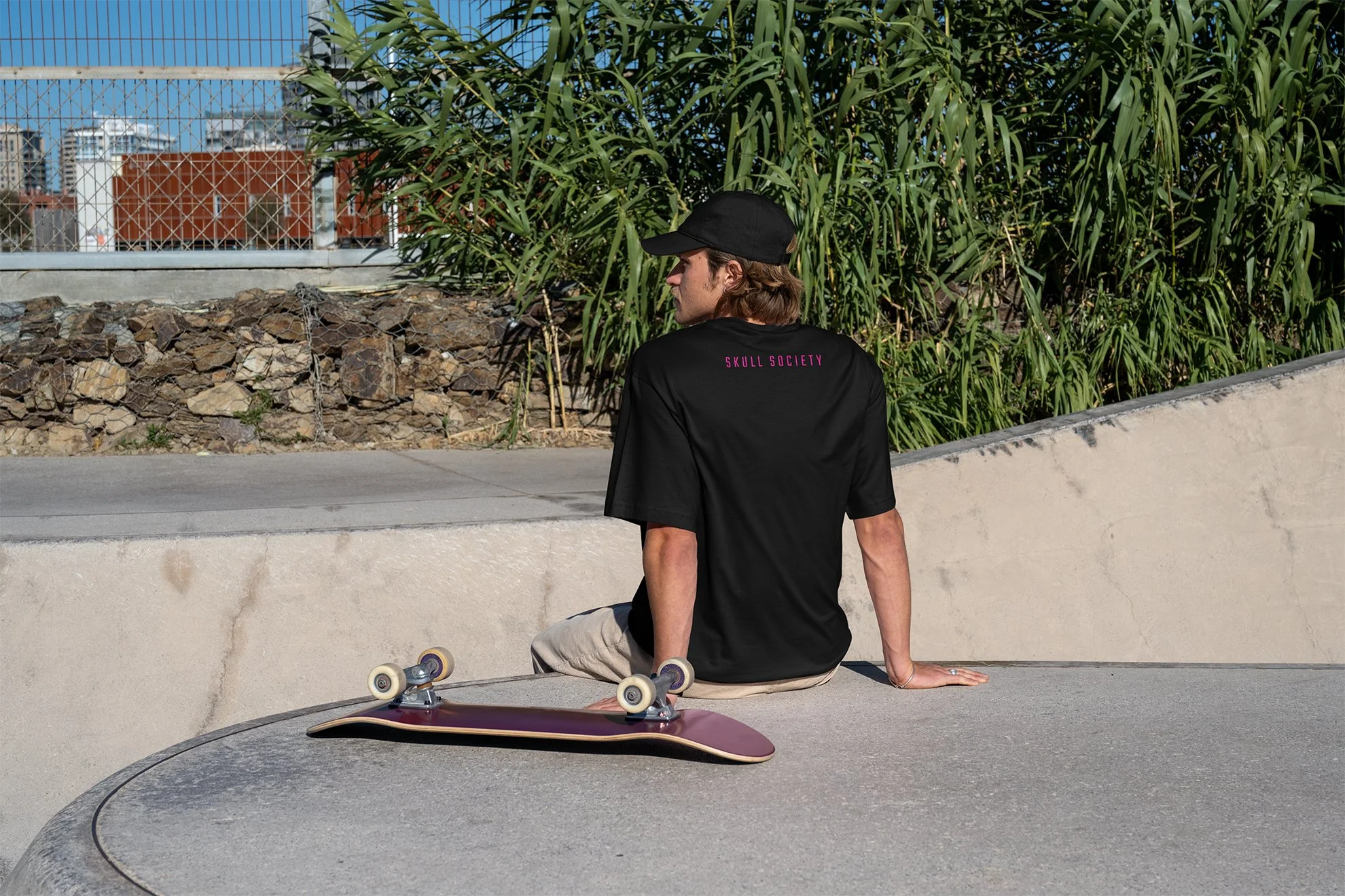 Skater boy wearing Skull Society at a skatepark.