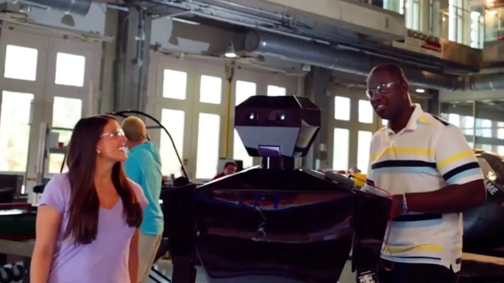 University of Oklahoma tv ad campaign still of engineering students with robot.