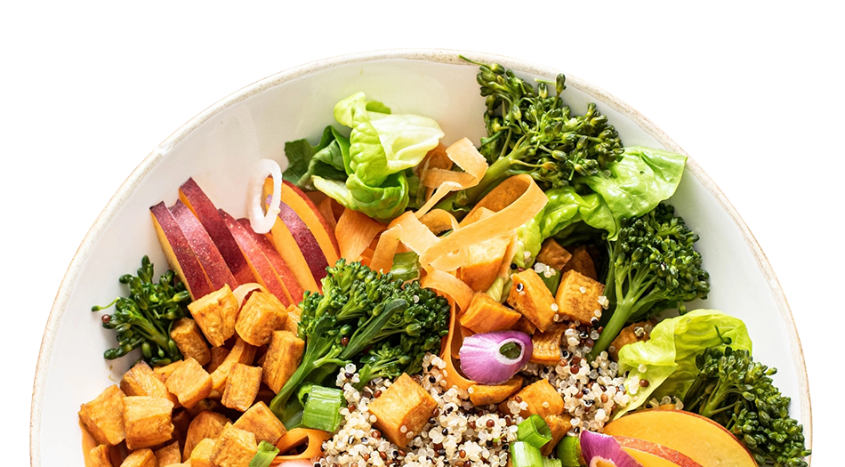 Mixed salad with broccoli, roasted tofu, sliced radish, lettuce, carrots, and quinoa.