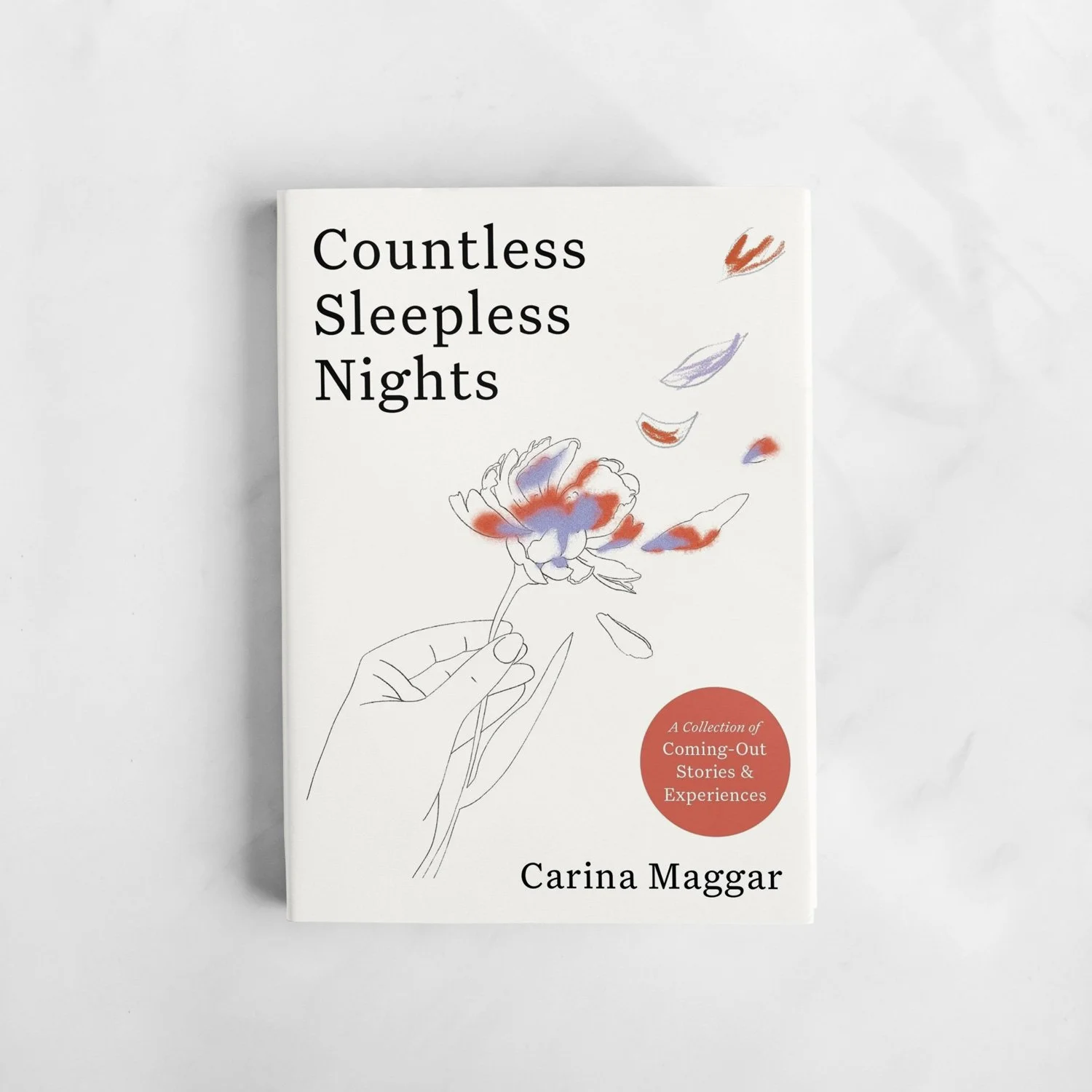 A white book titled 'Countless Sleepless Nights' by Carina Maggar with an illustration of a hand holding a flower with colored petals and a red sticker indicating 'A Collection of Coming-Out Stories & Experiences'