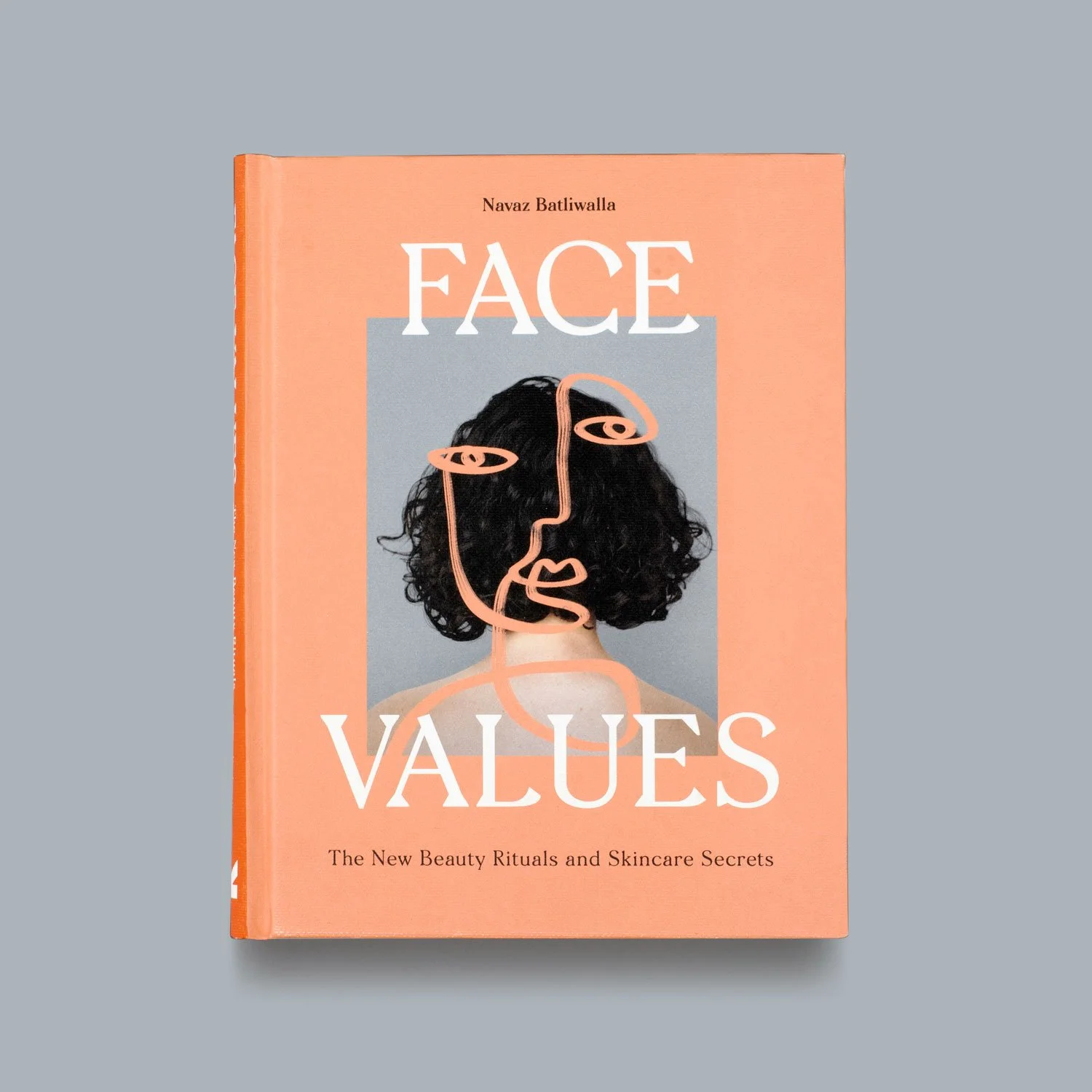 A book titled "Face Values" by Navaz Batliwalla with an abstract line drawing of a woman's face over a cover photograph of a woman with curly hair, set against a gray background.