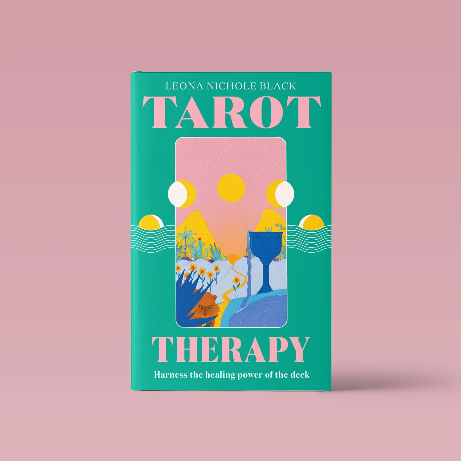 Book titled 'Tarot Therapy' by Leona Nichole Black. The cover features an abstract, colorful illustration of a landscape with mountains, trees, water, a lion, and a large goblet, set on a pink background.