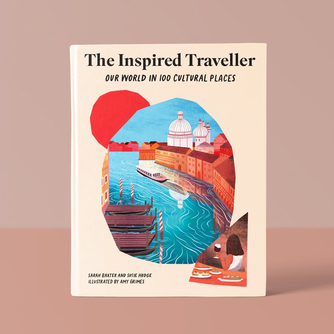 Book titled 'The Inspired Traveller: Our World in 100 Cultural Places' with an illustration of a European city canal, boats, historic buildings, and a person dining at a restaurant.