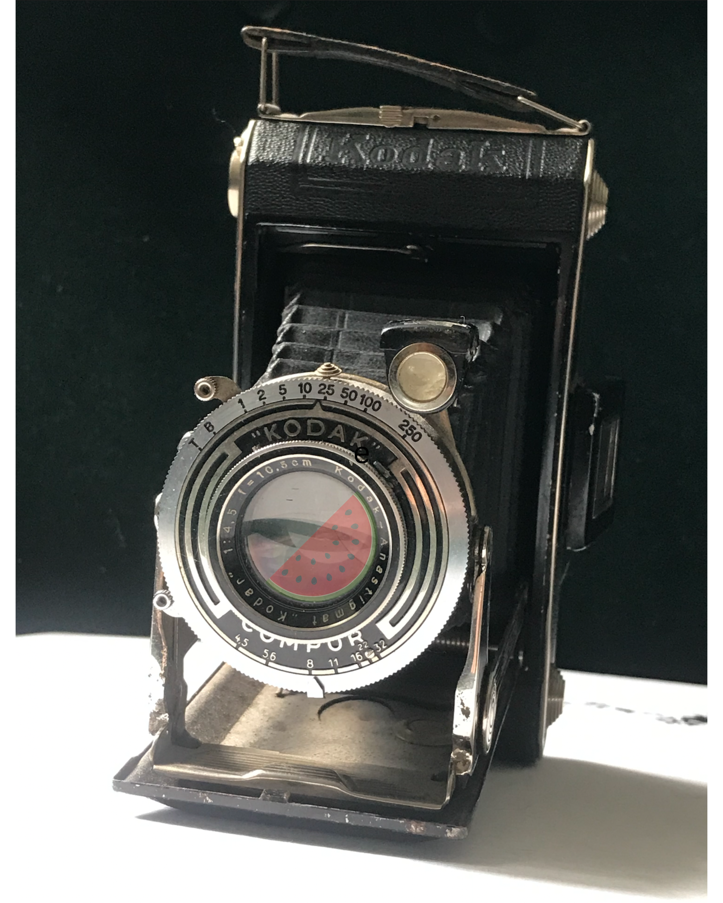 Vintage Kodak movie camera with a foldable black and silver body and a lens marked with 'Kodak' and 'Ektosport'.