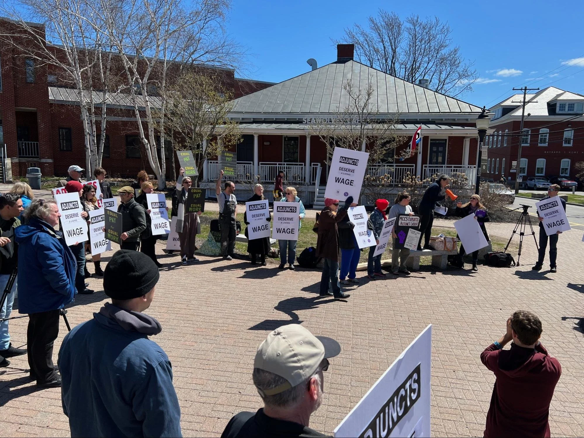 Andrea is at an outdoor protest event and can be seen amongst a group of fellow union members.