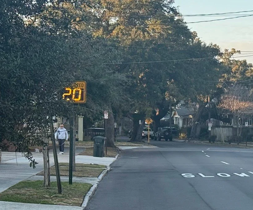 Speed Feedback signs with road with SLOW markings on it