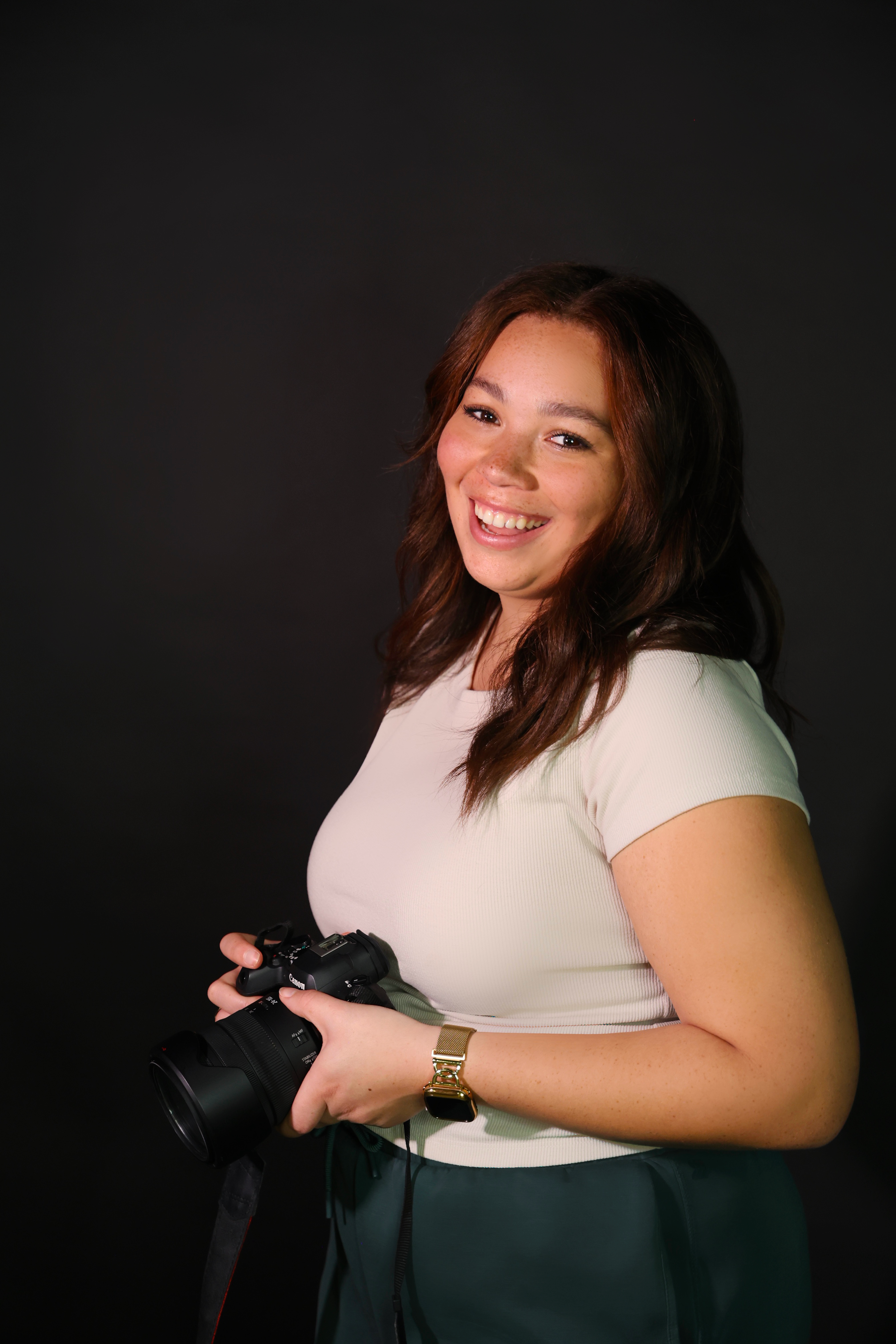 This represents a studio portrait of a fellow classmate, Alexis Good. This image was captured to help build Alexis' professional portfolio and helps reflect one of her many skills as a Visual Communications student, photography. This image represents