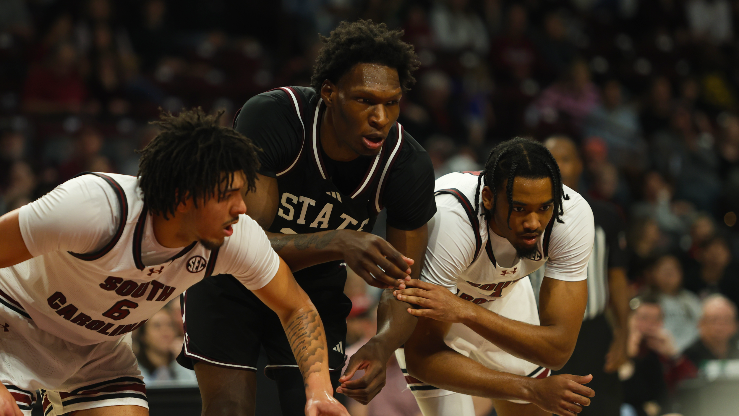 Freshman (left) E.J. Walker (#6) and redshirt senior (right) Kobe Knox (#4) get set along the lane as they box out a Mississippi State player ahead of a free throw during South Carolina’s 97–89 win.