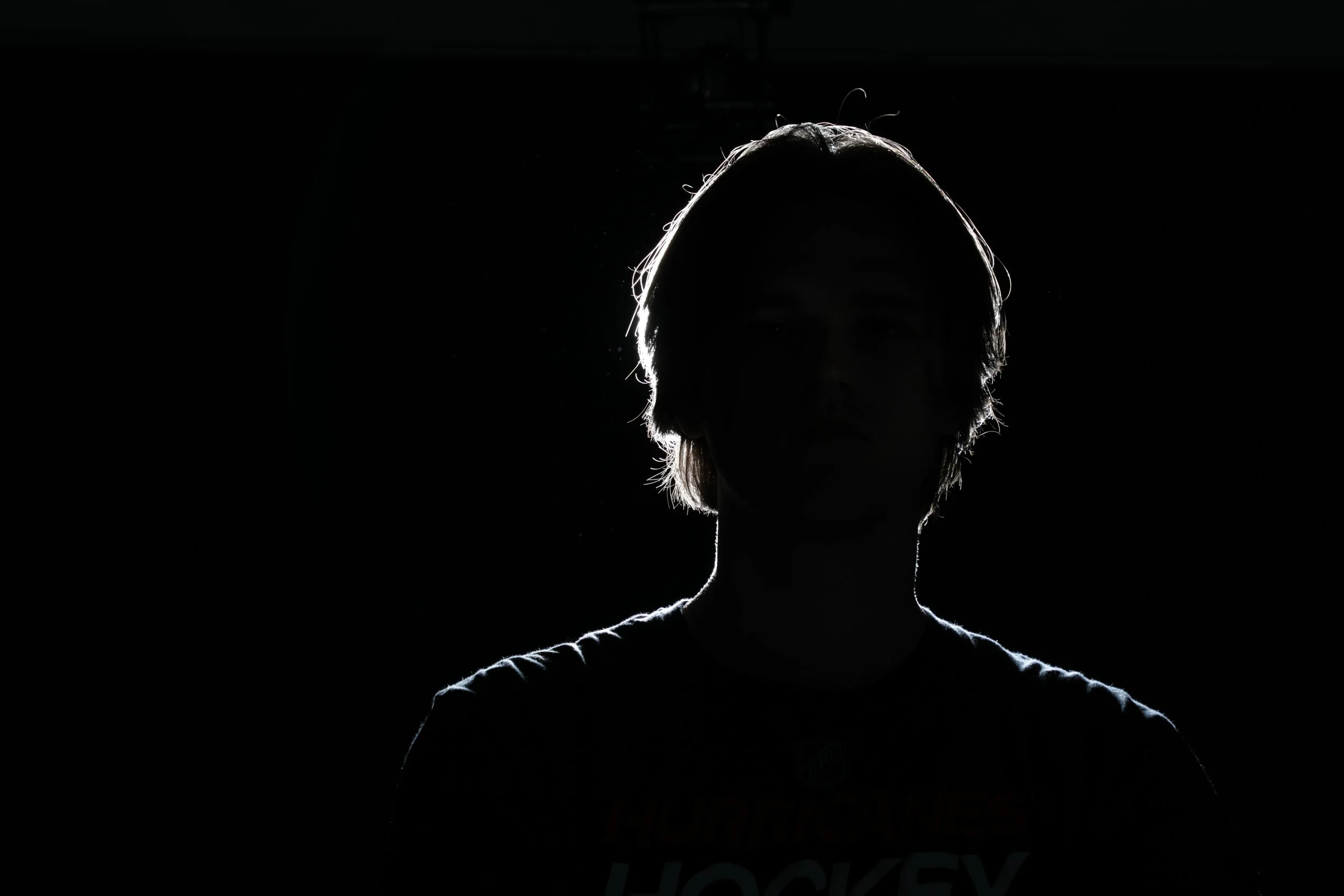 This image is in part a collection of a separate portrait photography session focused on exploring well-known lighting techniques in a studio environment. Featuring model Elijah Rogers, this photograph demonstrates the use of rim lighting to create a