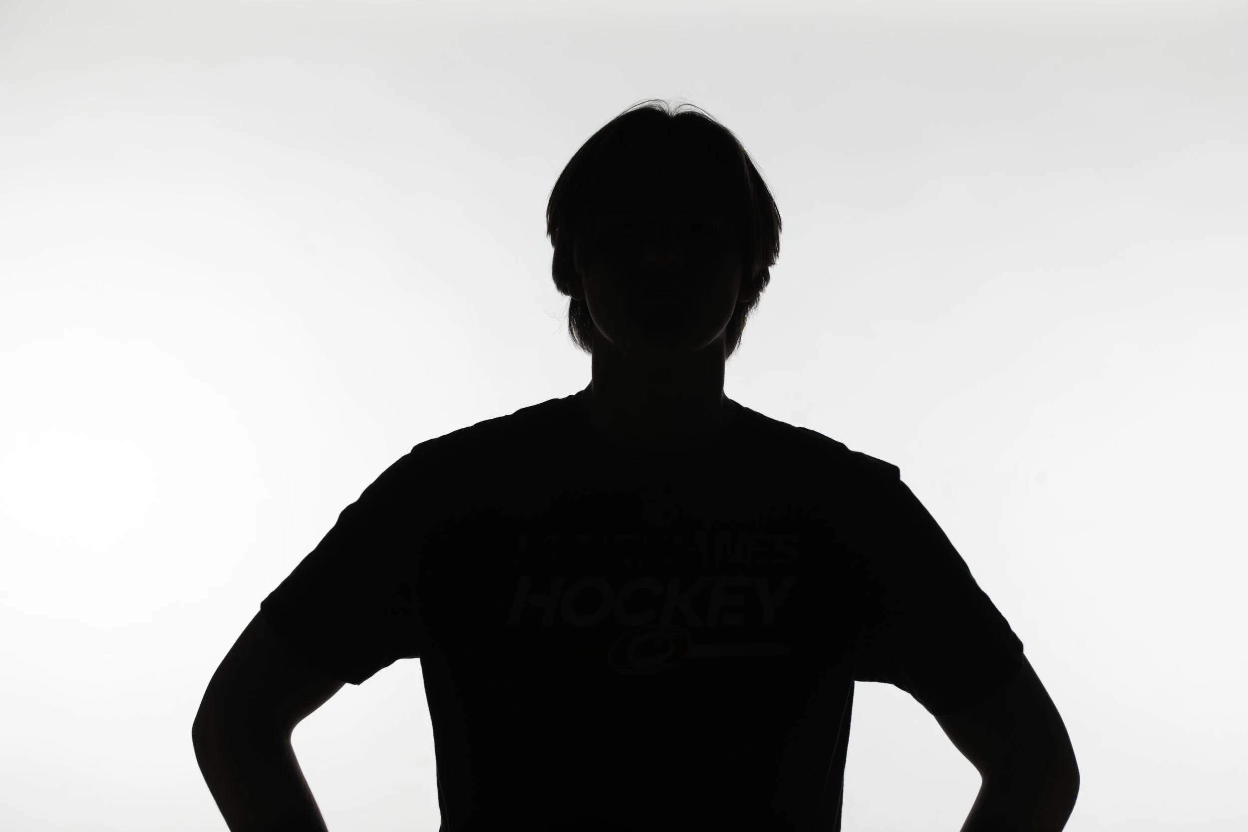 Another portrait session featuring model Elijah Rogers, focusing on a high-contrast silhouette technique. Unlike the rim-lit version, this setup uses strong backlighting against a bright background to create a bold, graphic outline of the subject. Th