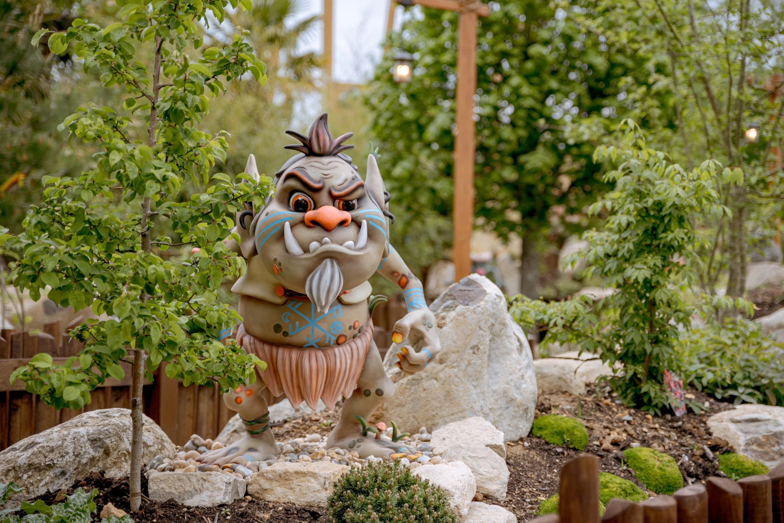 Cheeky characterful troll statue in queue line for Paultons Park ride Vild Swing.