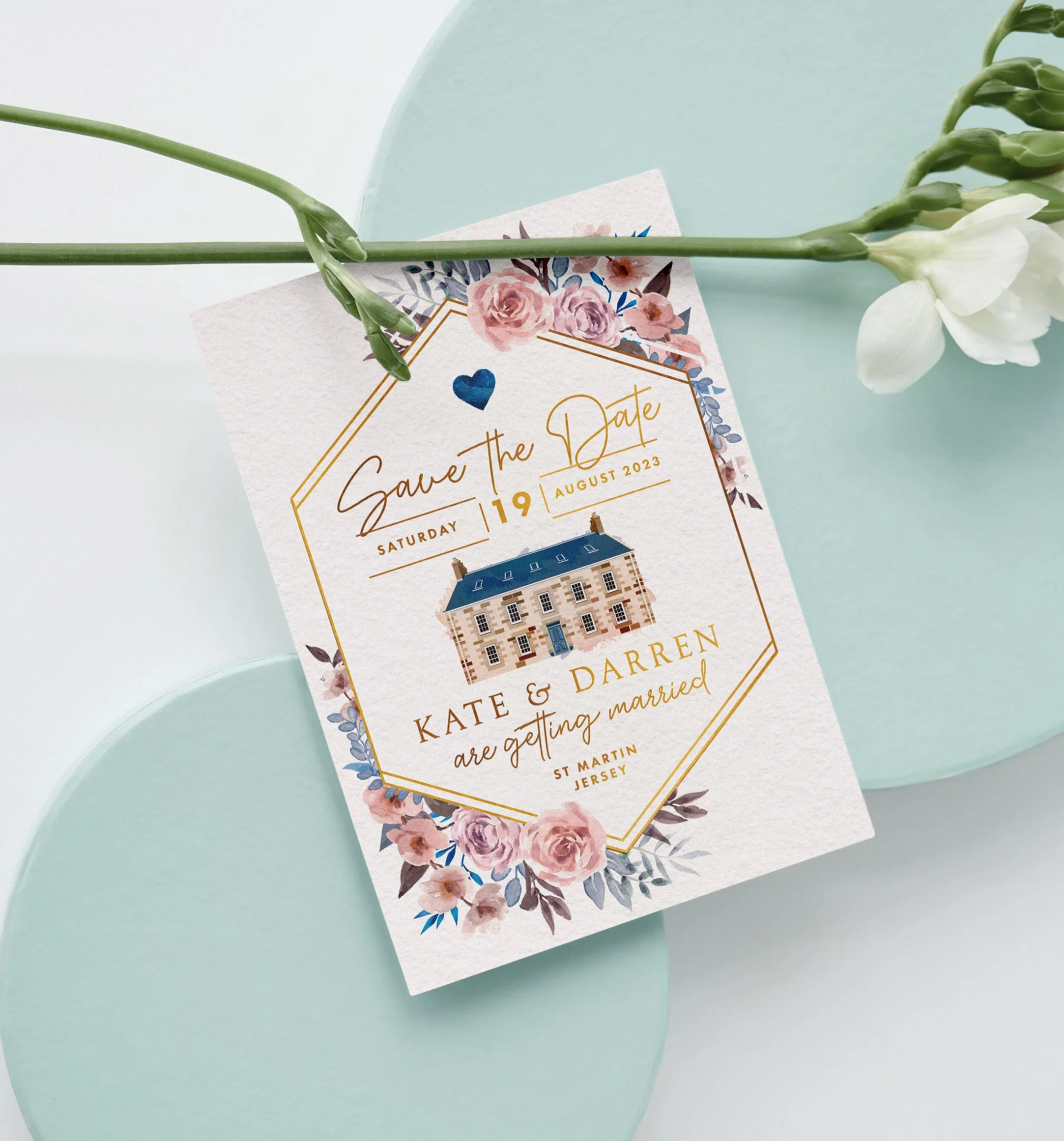 Save the date floral design featuring decorative flowers, building illustration and gold lettering