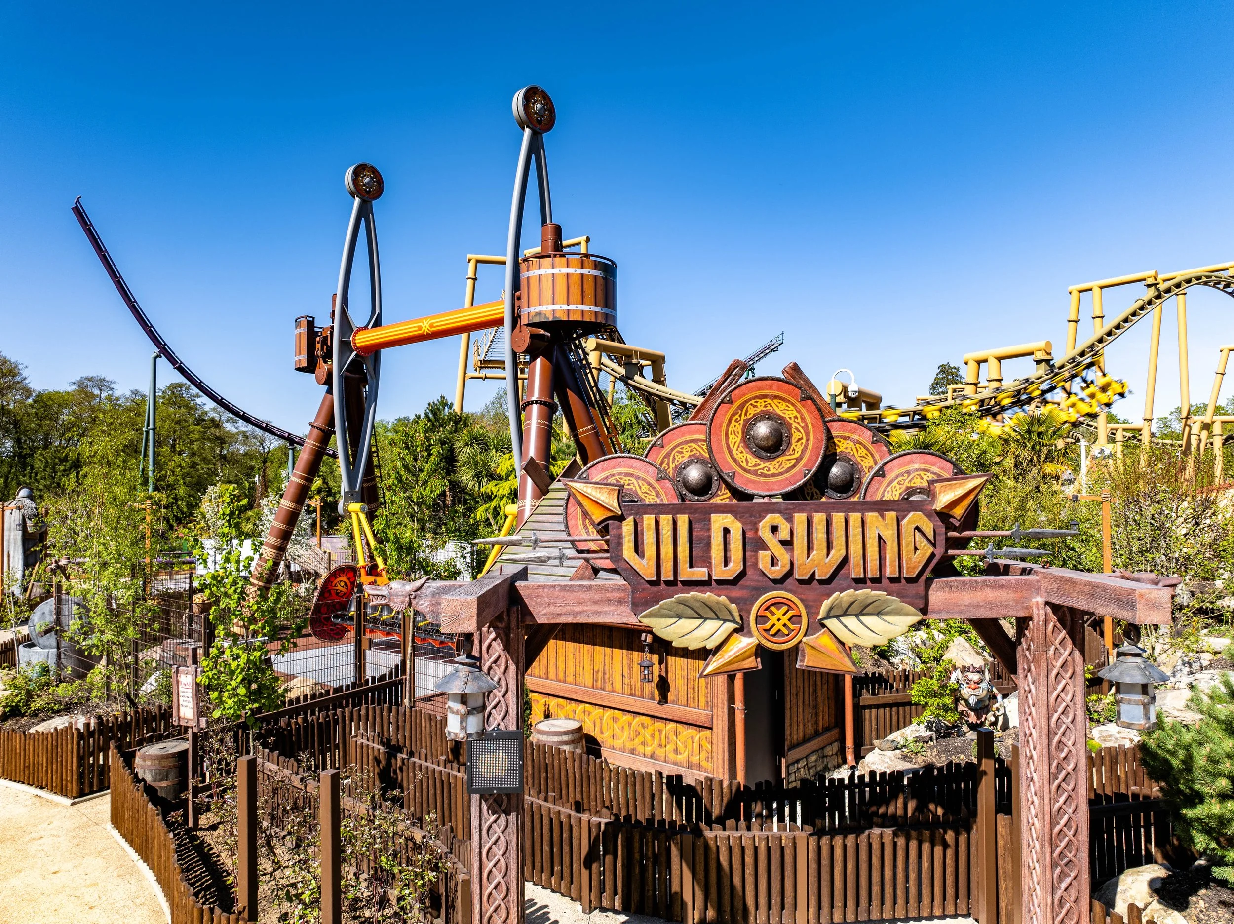 A Viking-themed amusement park ride called Vild Swing at Paultons Park with ornate wooden decorations and Viking motifs.