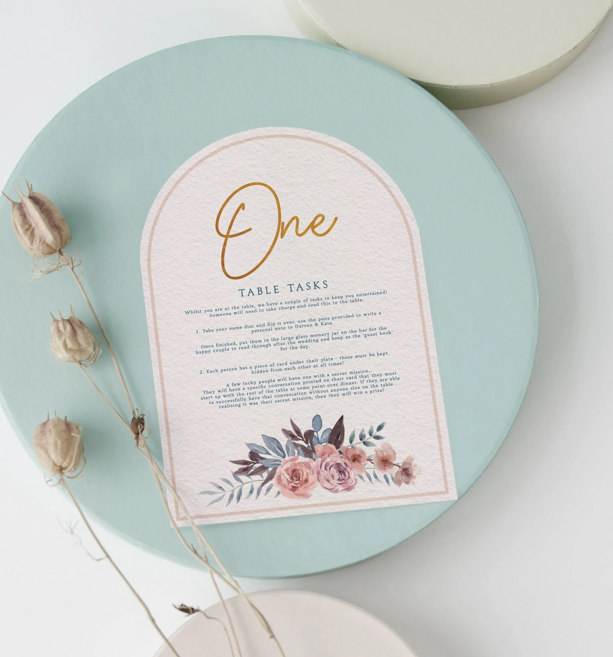 Wedding table number one featuring floral design, gold lettering and table tasks.