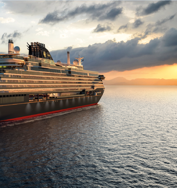 A large cruise ship on the ocean during sunset, with clouds and a distant mountain range in the background.