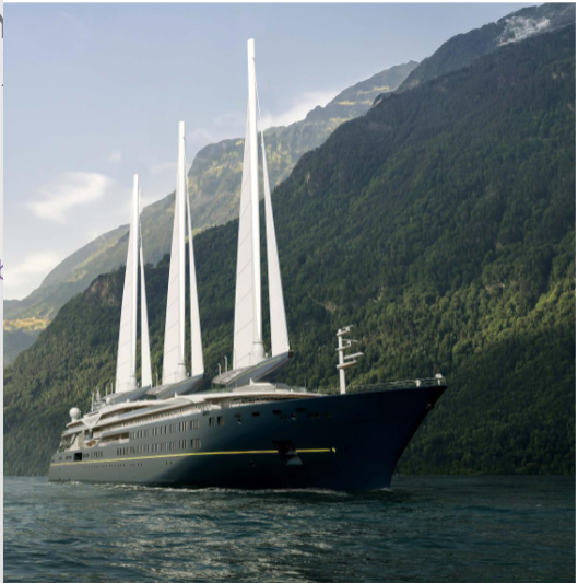 A large sailing yacht with multiple white sails navigating through a deep body of water with green mountains in the background.