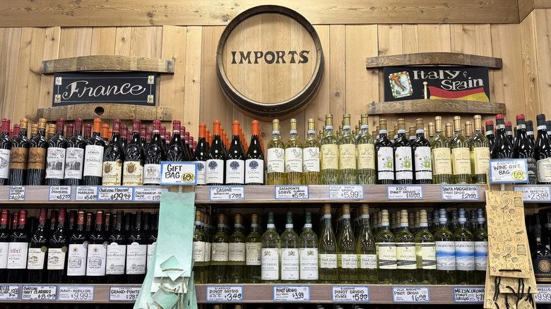 A picture of the wine aisle at Trader Joe's with different types of white and red wine and a sign saying France and Italy & Spain above the bottles