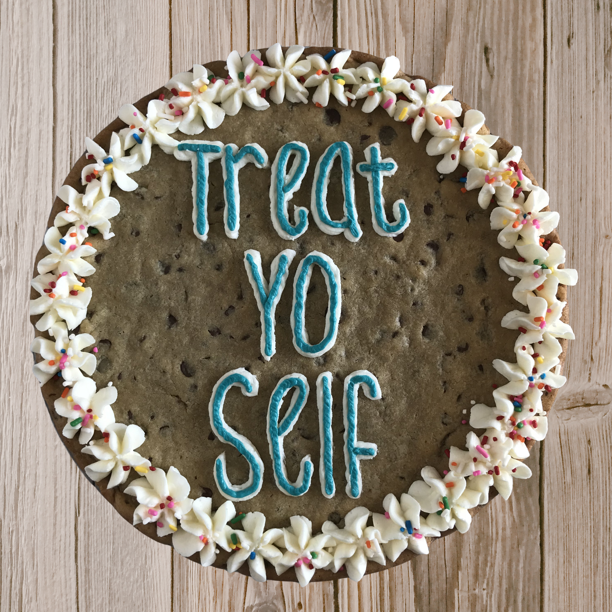 A large simply designed cookie cake by Cara, the owner of Duck Duck Goose Bakery.