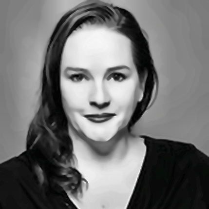 Black and white portrait of a woman with long wavy hair, smiling, wearing a dark top.