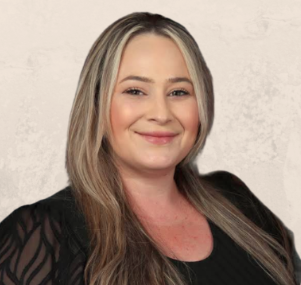 A woman with blonde hair, smiling, wearing a black top, standing against a light-colored textured background.