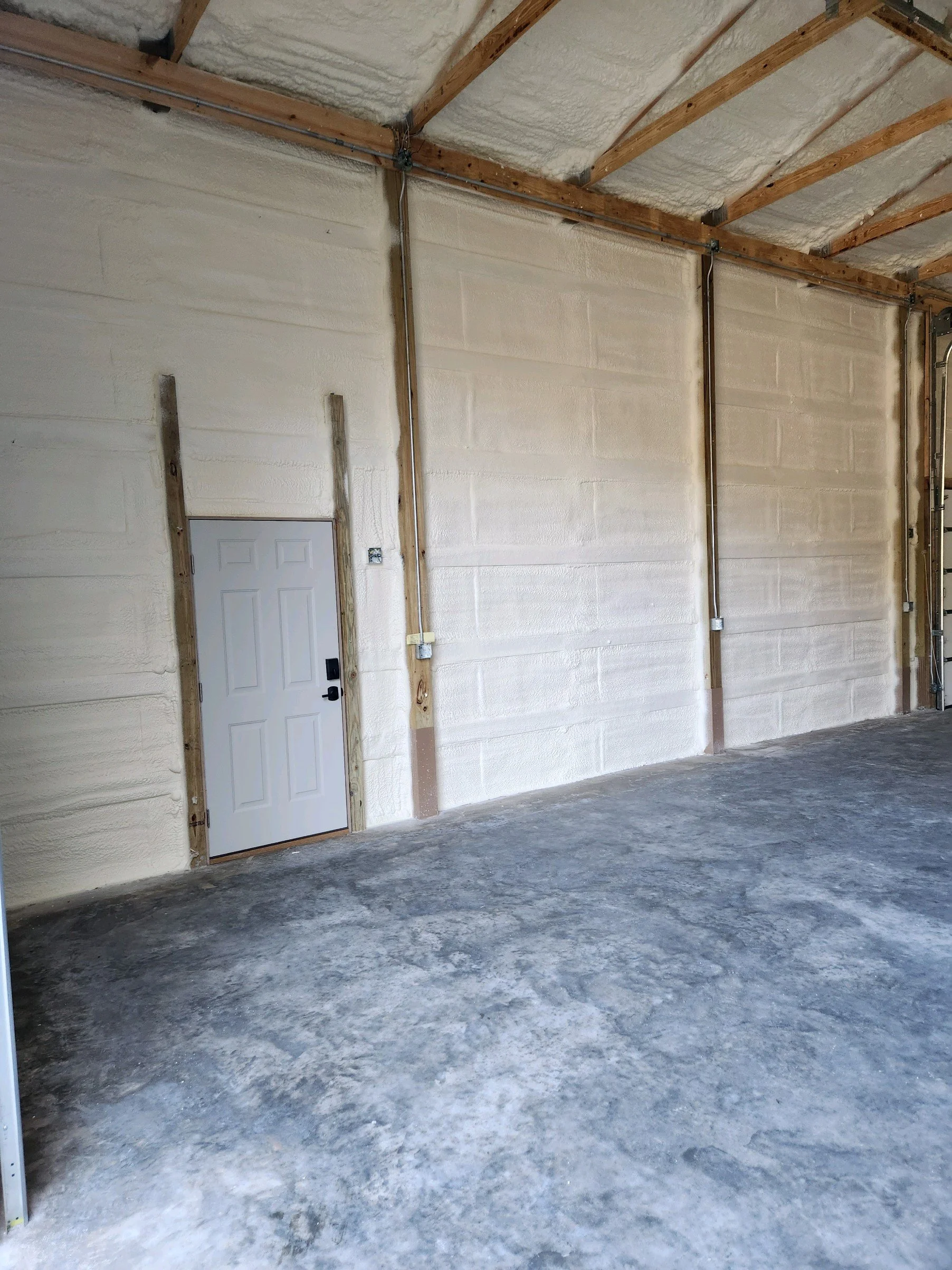 spray foamed wall with door