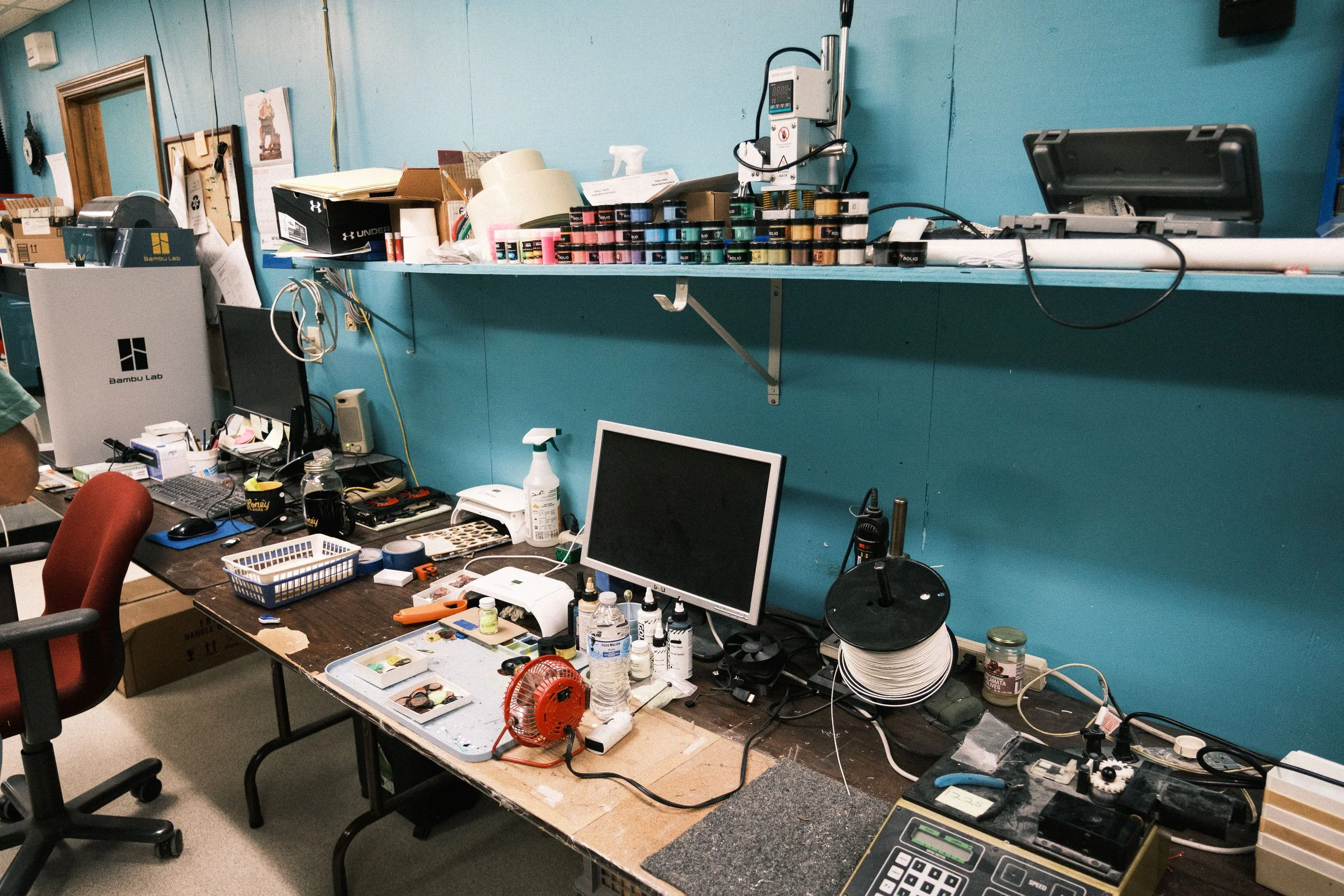   The workstation for filling in logos and designs. They used to use paint and now they use resin with pigment added to it; It fills the gaps way more evenly.  