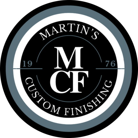 Logo for Martin's Custom Finishing, featuring a black circle with white and blue text and design elements.