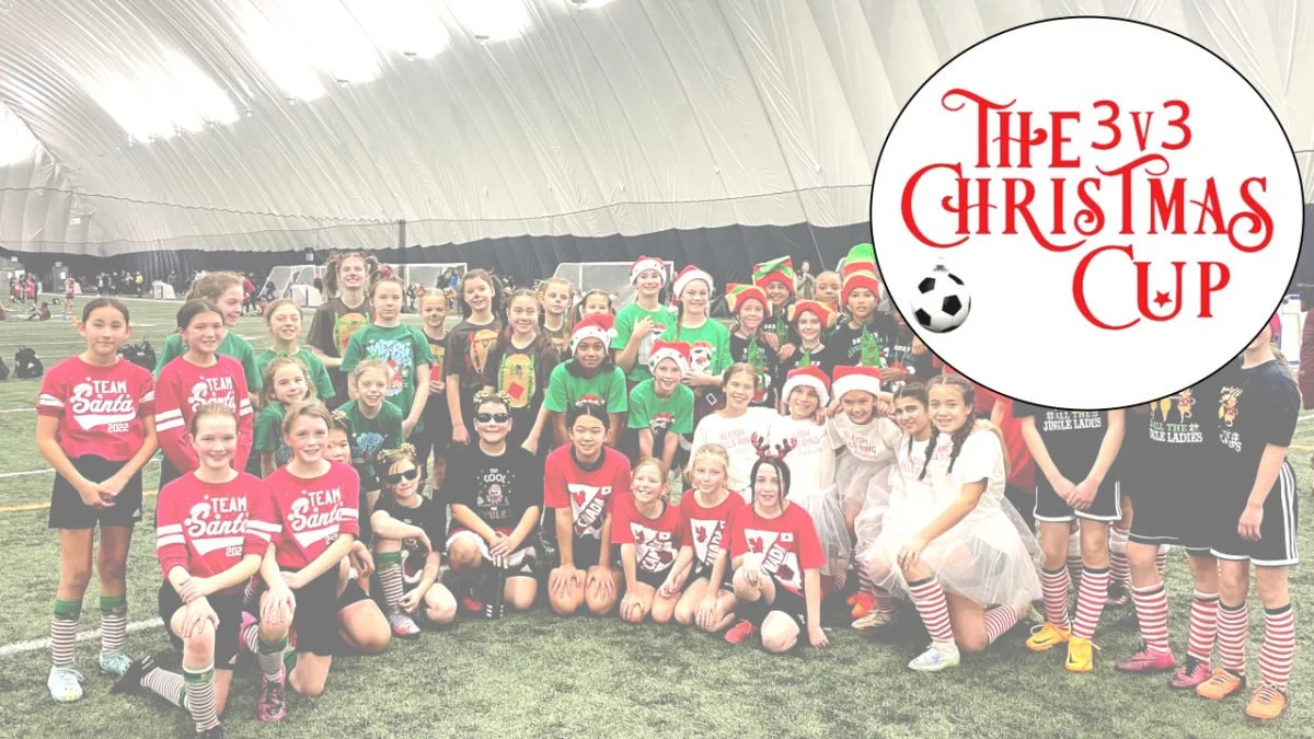 Group of children in Christmas-themed sports attire and costumes, posing inside a large indoor sports dome. There's a festive logo in the top right corner reading 'The 3v3 Christmas Cup' with a soccer ball.