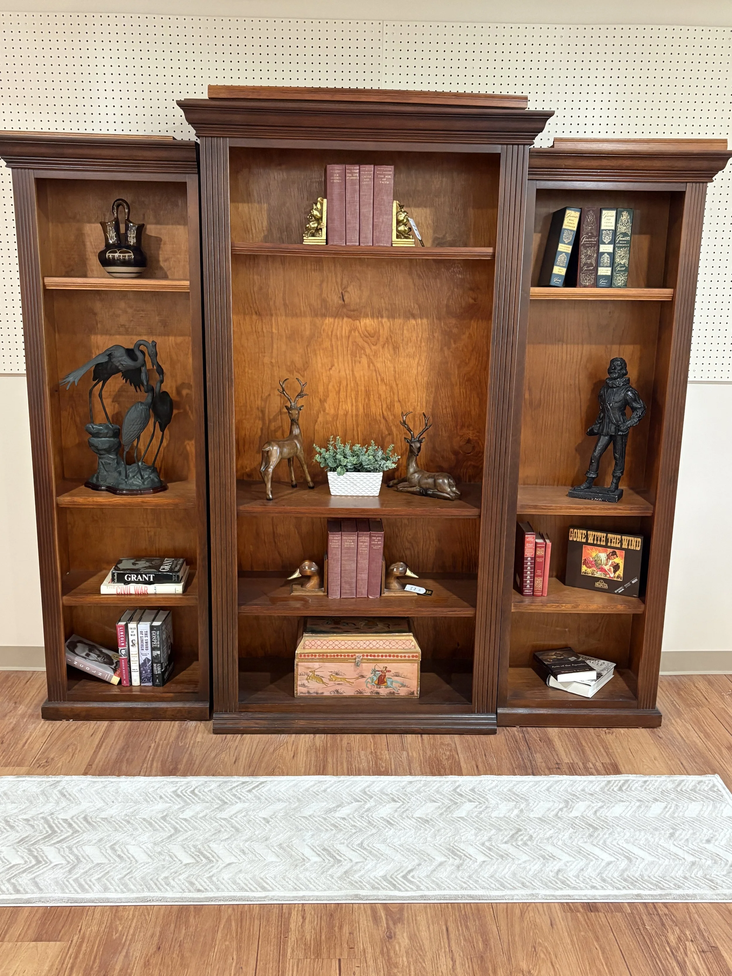 Bookshelves with many statues, books, and figures.