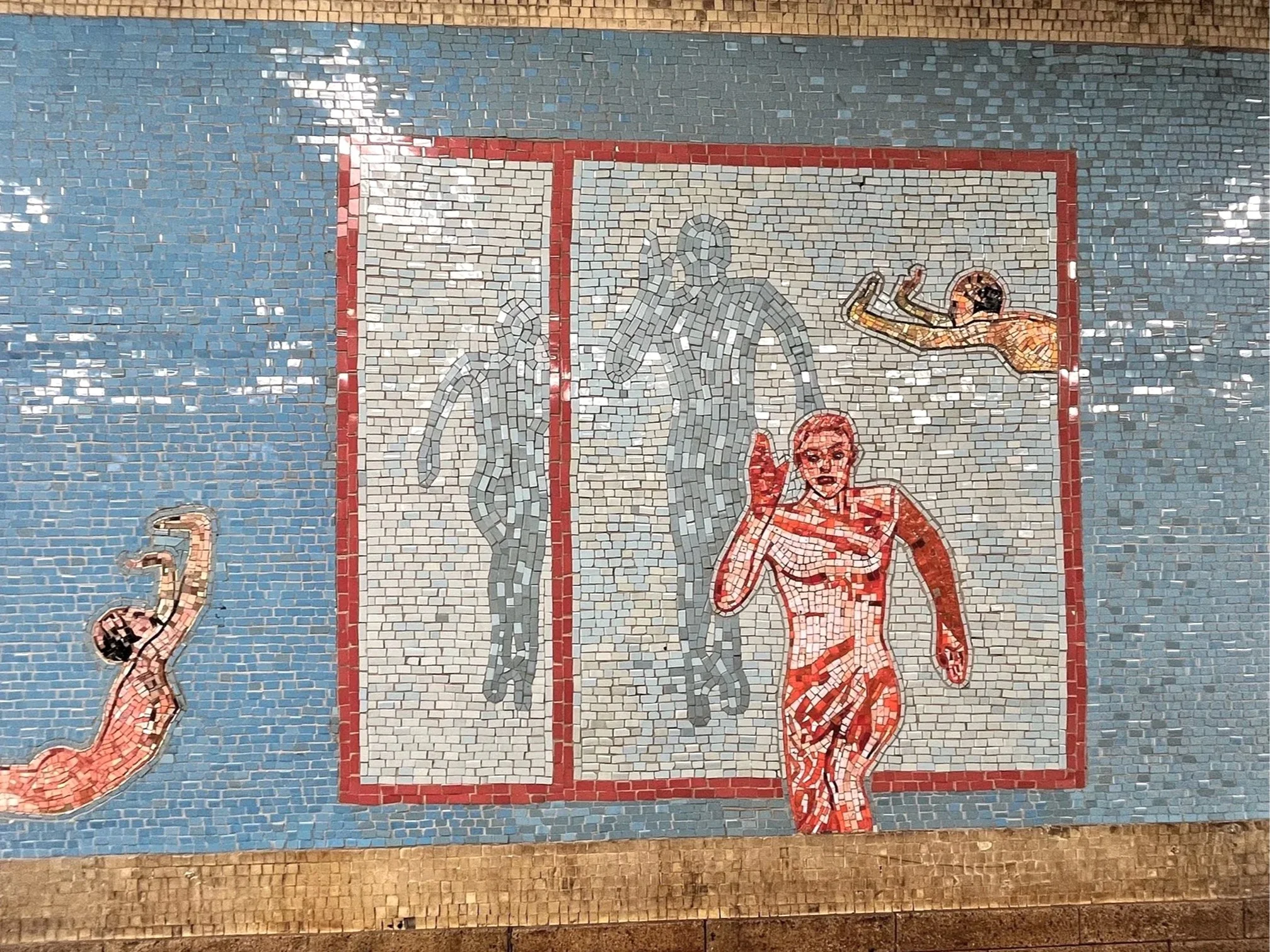 Mosaic mural depicting athletes swimming and running, with a focus on a female swimmer in the foreground and overlaid figures of runners in the background.