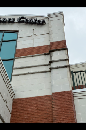 dirty and moldy brick and stucco commercial building