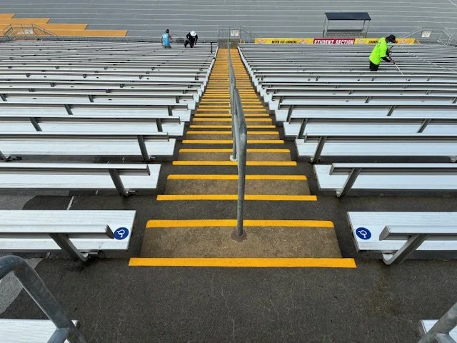 dirty bleacher seats and steps at a local university football stadium