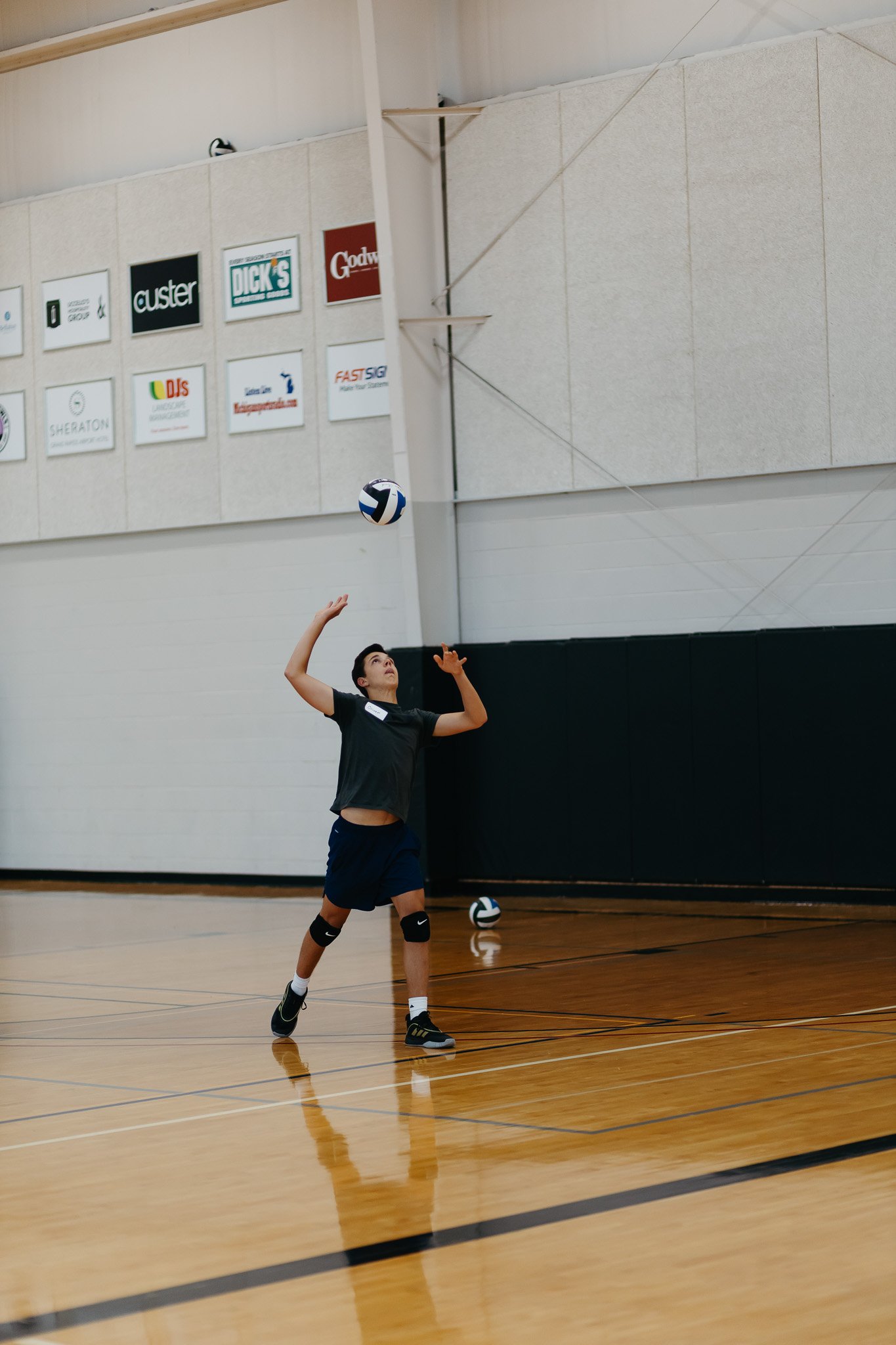 teenage boy volleyball player working on serving and ball control at a volleyball clinic at MSA Fieldhouse in Grand Rapids