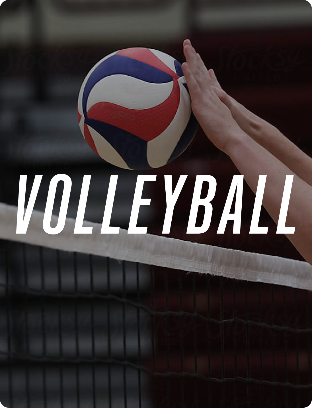 A volleyball being spiked over a net during a game.