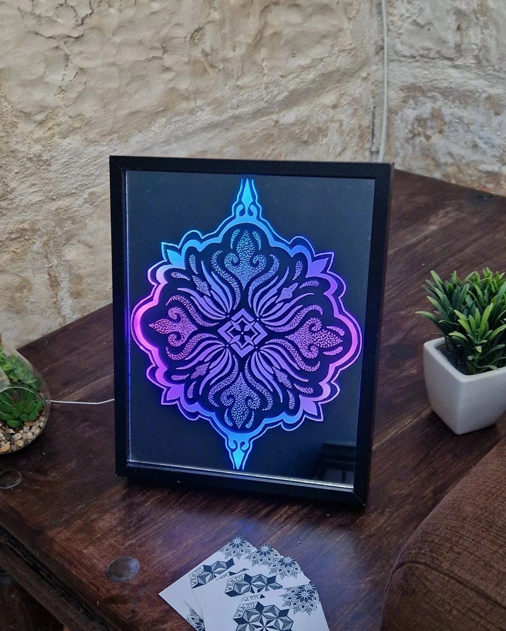 CARVED IN GLASS

From my tattoo flash book to a glowing mirror. This mandala is engraved on the back of a mirror, lit from behind with LEDs so the etched lines glow. A technique I used years ago — but never like this. Feels good as an artist to creat
