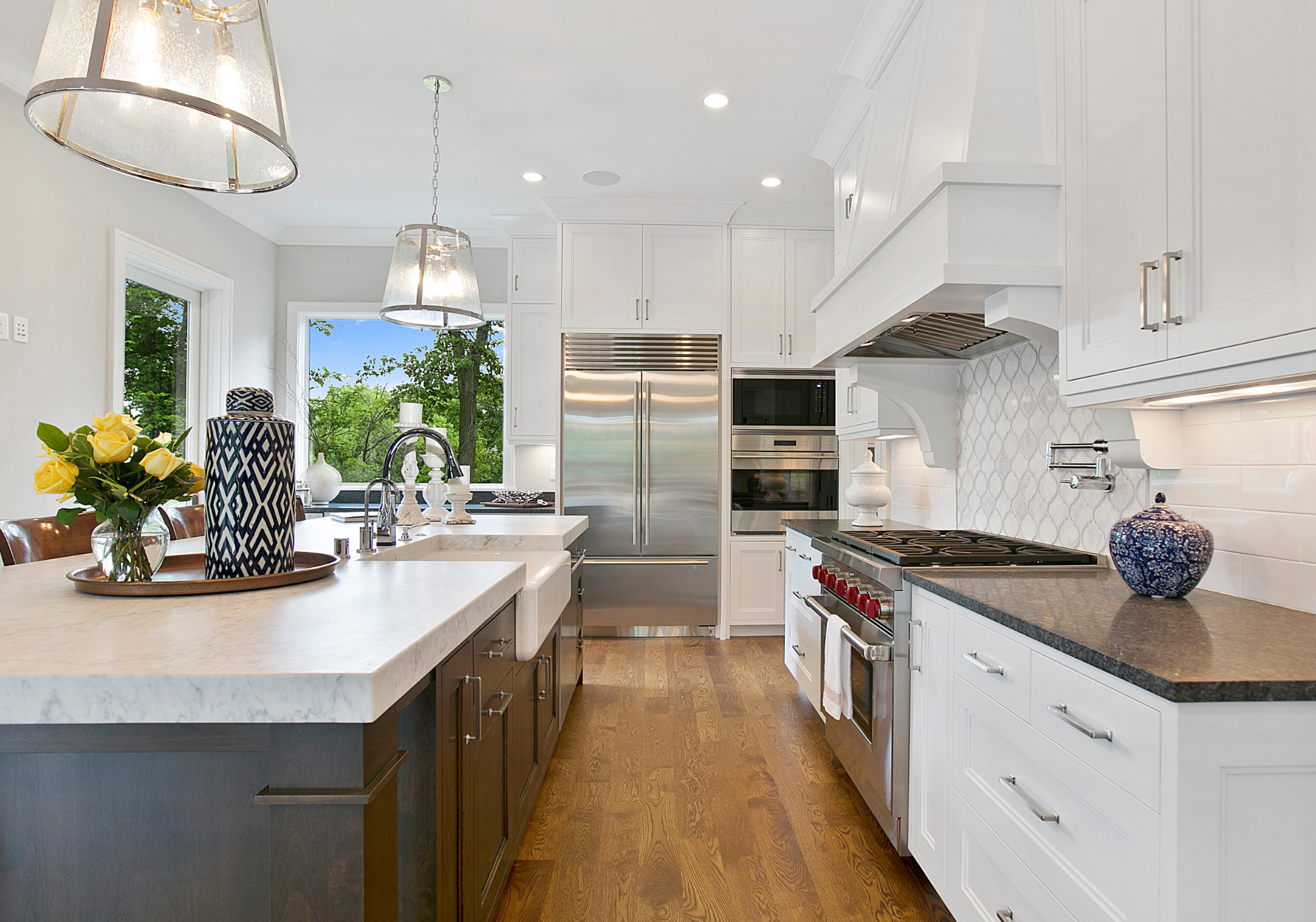 A high-end kitchen with white cabinetry and professional-grade appliances, showcasing the "Architectural Eye" and technical insight Monica O'Keefe uses during the patient home search and criteria calibration process.