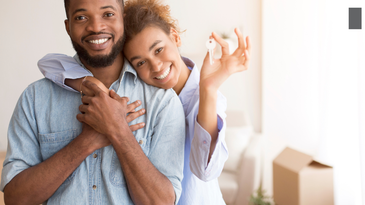 A happy couple holding the keys to their new home, illustrating the "stress-free and exciting" results Monica O'Keefe delivers through technical precision and expert advocacy.