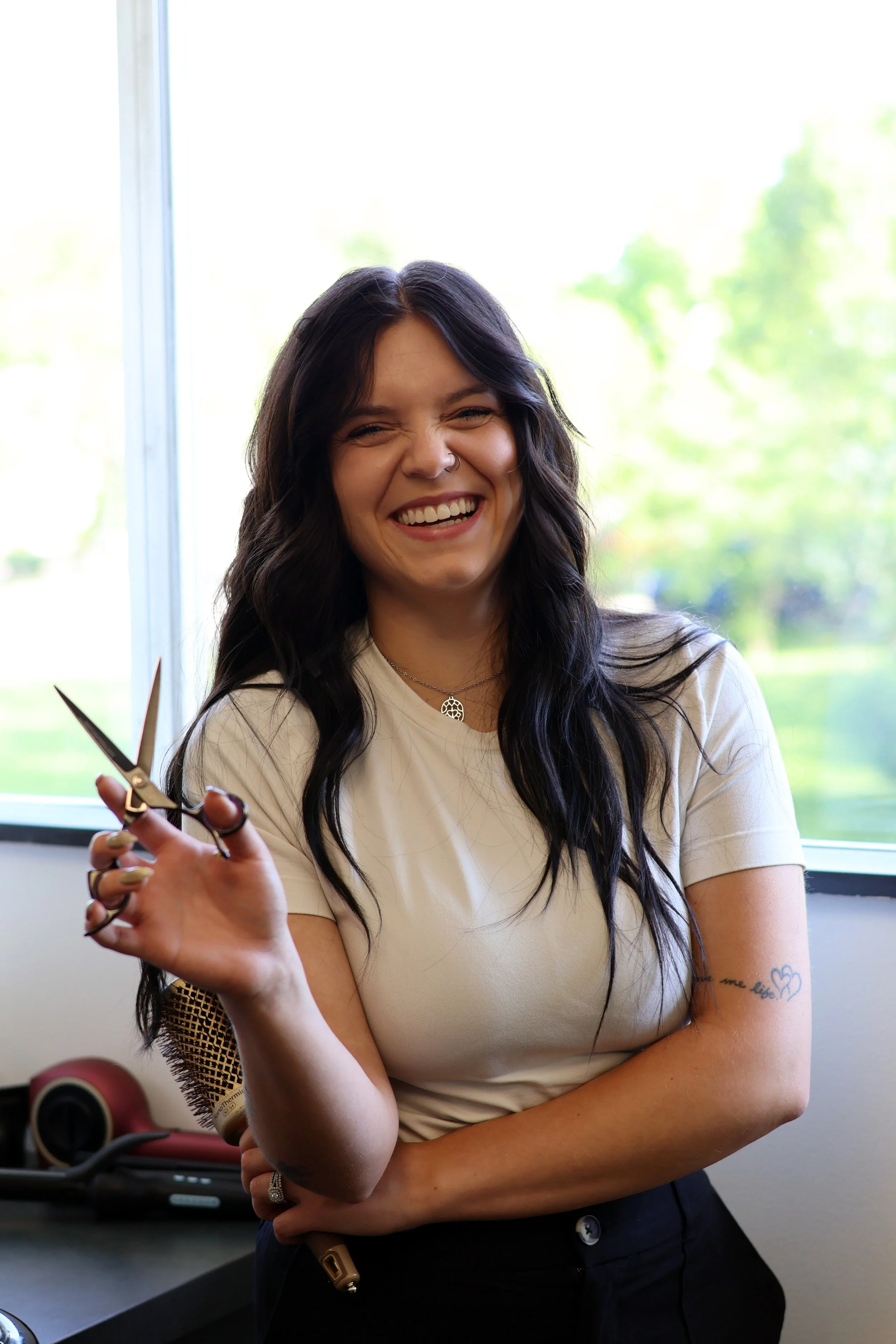 dark hair styling posing with hair sheers